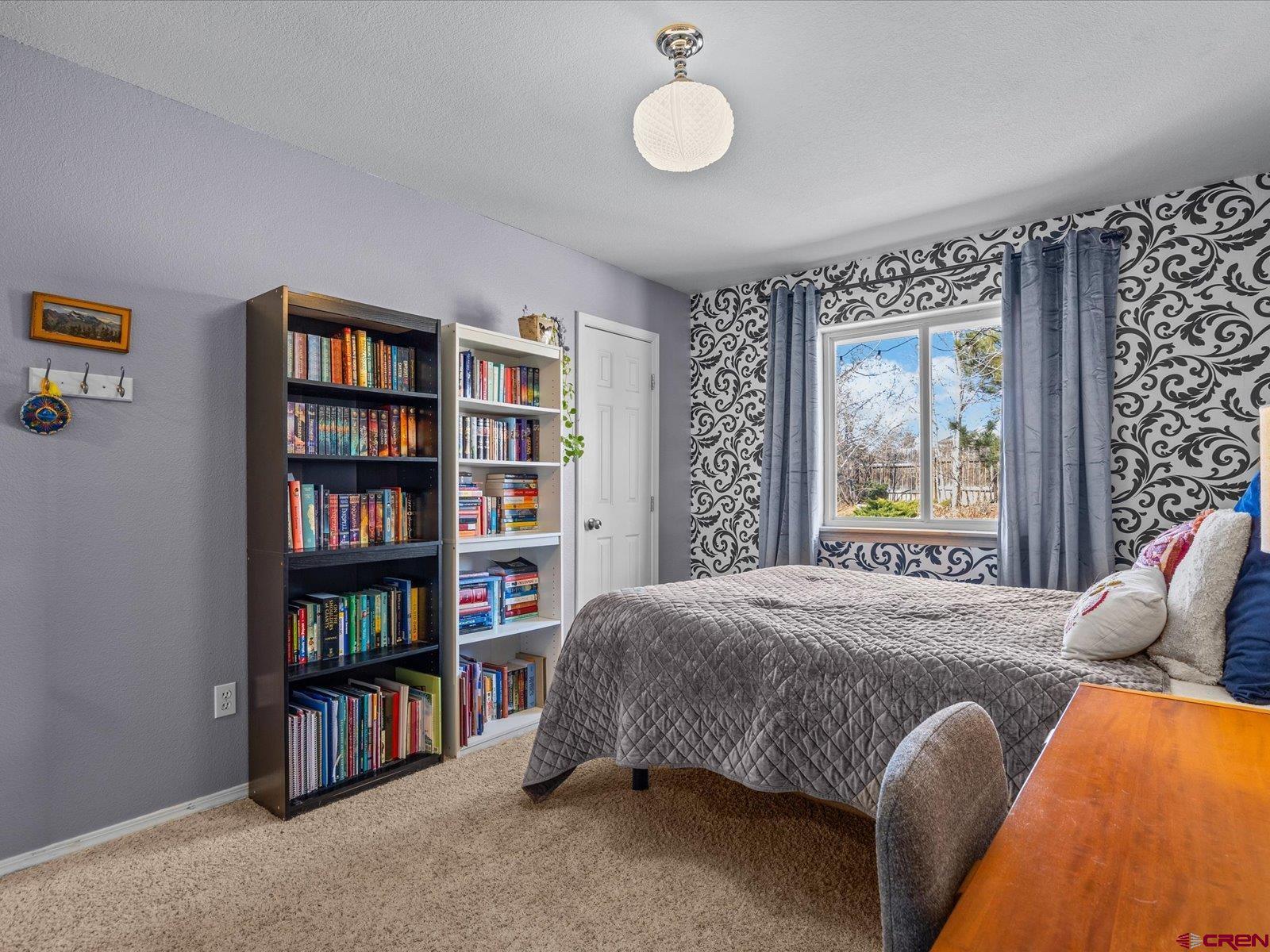 16222 6830th Road Montrose, CO 81401 - Photo 22 of 34 a bedroom with a bed and a book shelf