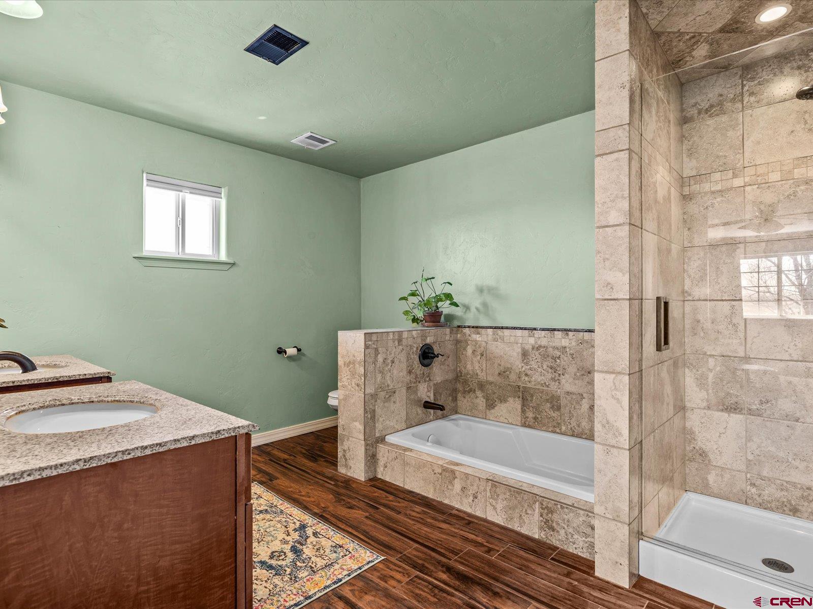 16222 6830th Road Montrose, CO 81401 - Photo 23 of 34 a bathroom with a granite countertop sink and a mirror