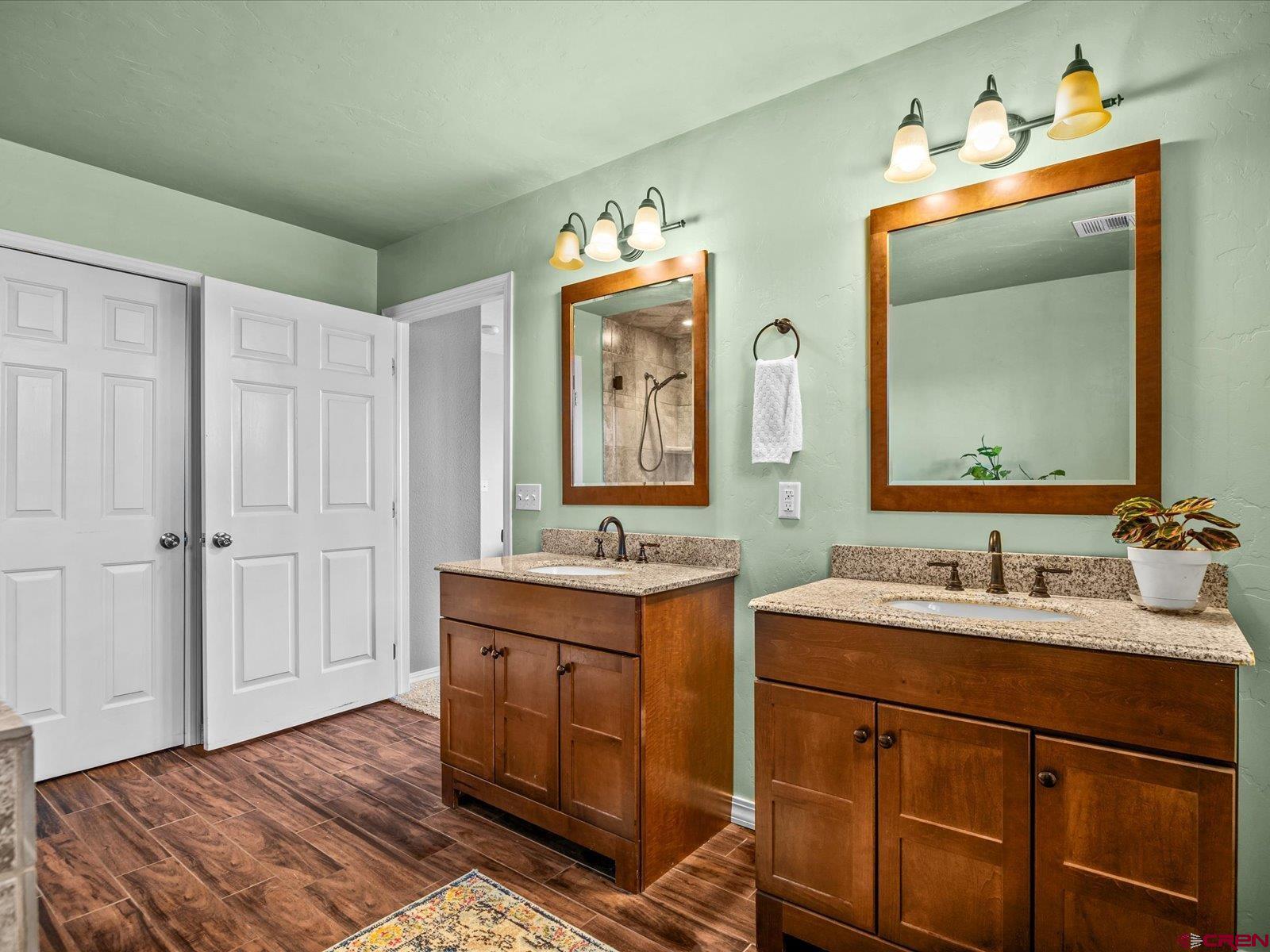 16222 6830th Road Montrose, CO 81401 - Photo 24 of 34 a bathroom with a double vanity sink and a mirror