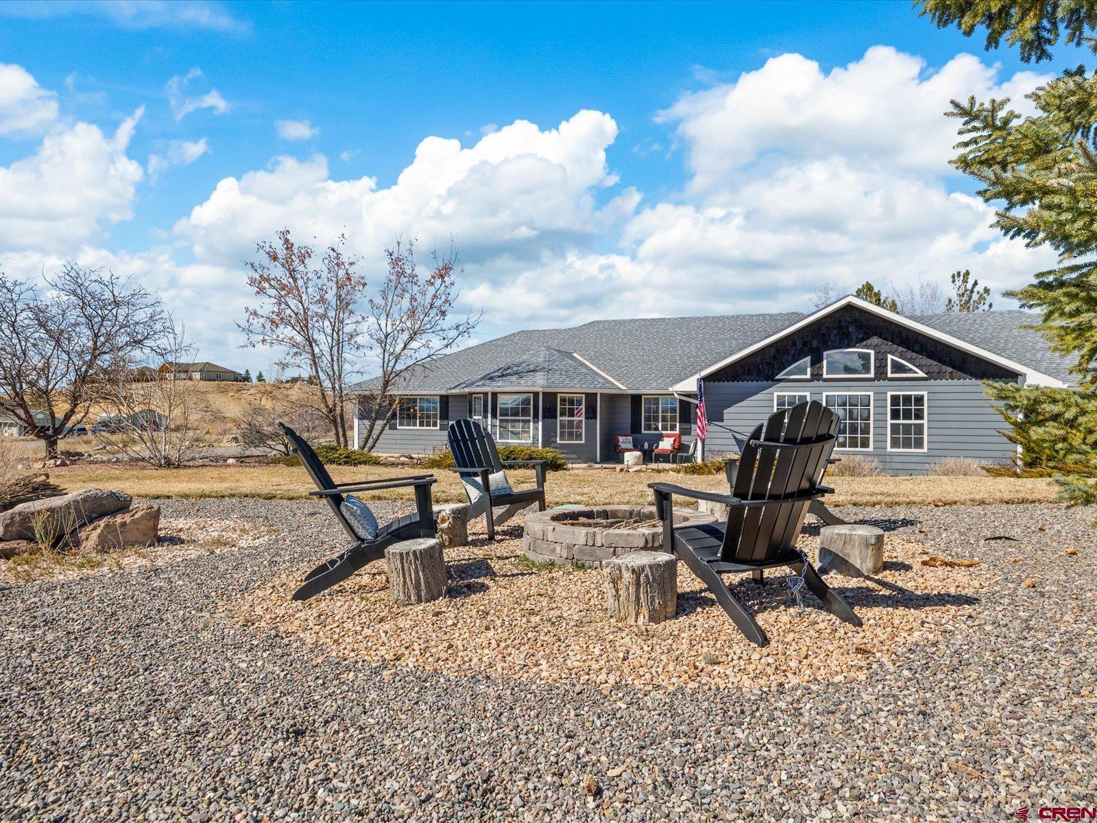 16222 6830th Road Montrose, CO 81401 - Photo 29 of 34 a white house with a large tree in front of it