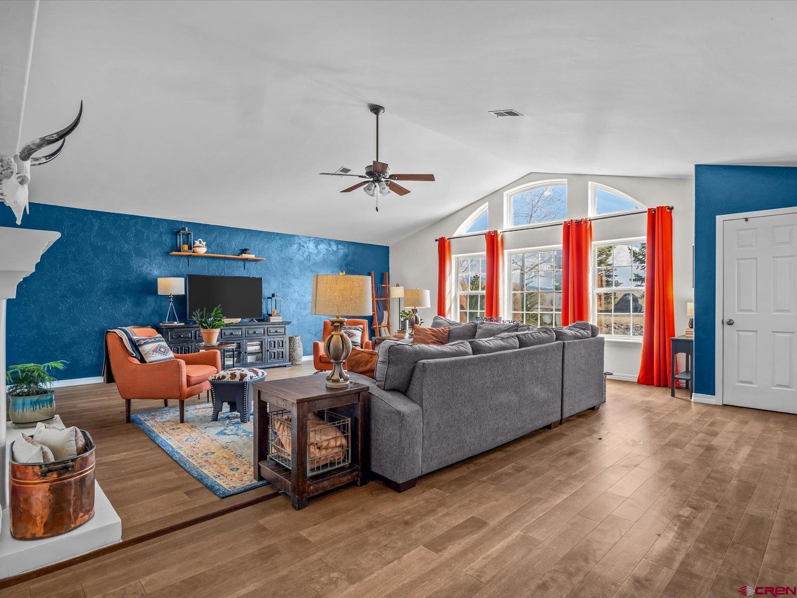 16222 6830th Road Montrose, CO 81401 - Photo 5 of 34 a living room with furniture a flat screen tv and a large window