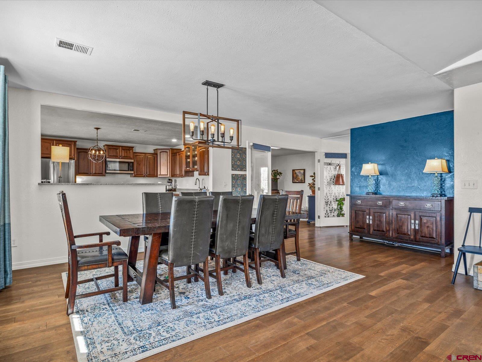 16222 6830th Road Montrose, CO 81401 - Photo 7 of 34 a view of a dining room with furniture and wooden floor