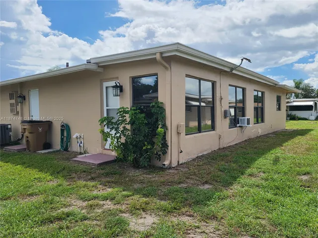 a view of a house with a yard and plants