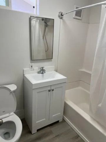 a bathroom with a sink toilet and shower