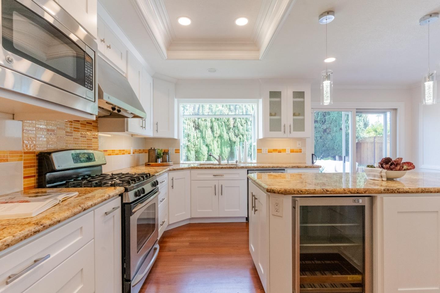 207 Post Street Mountain View, CA 94040 - Photo 12 of 60 a kitchen with granite countertop stainless steel appliances a stove sink and microwave
