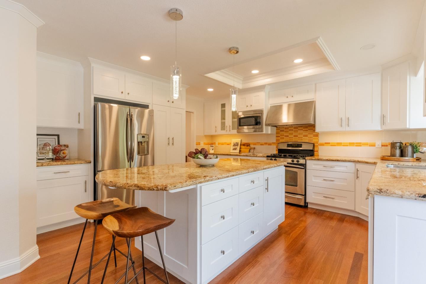 207 Post Street Mountain View, CA 94040 - Photo 14 of 60 a kitchen with stainless steel appliances kitchen island granite countertop a refrigerator and a stove top oven