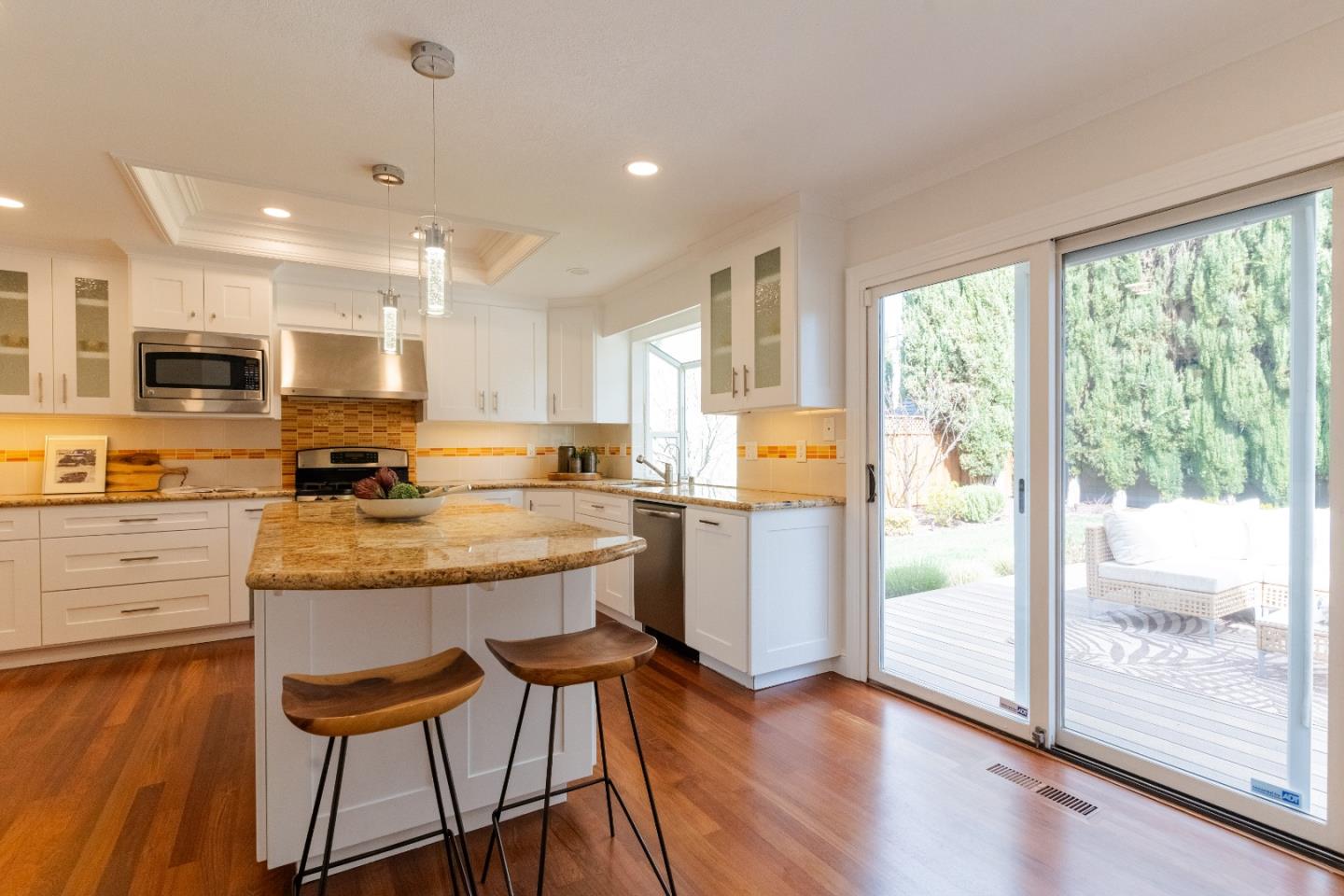 207 Post Street Mountain View, CA 94040 - Photo 15 of 60 a kitchen with stainless steel appliances granite countertop wooden floor a stove a refrigerator and island with wooden floor