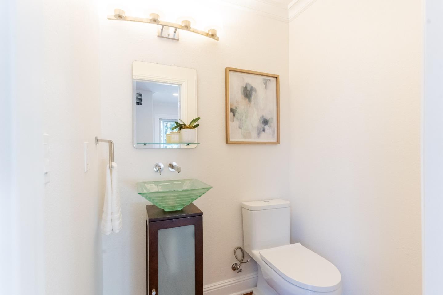 207 Post Street Mountain View, CA 94040 - Photo 21 of 60 a bathroom with a sink a toilet and a mirror