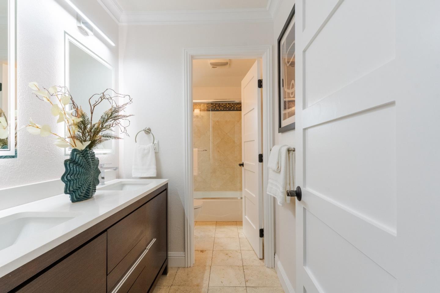 207 Post Street Mountain View, CA 94040 - Photo 38 of 60 a bathroom with a granite countertop sink a mirror and a shower