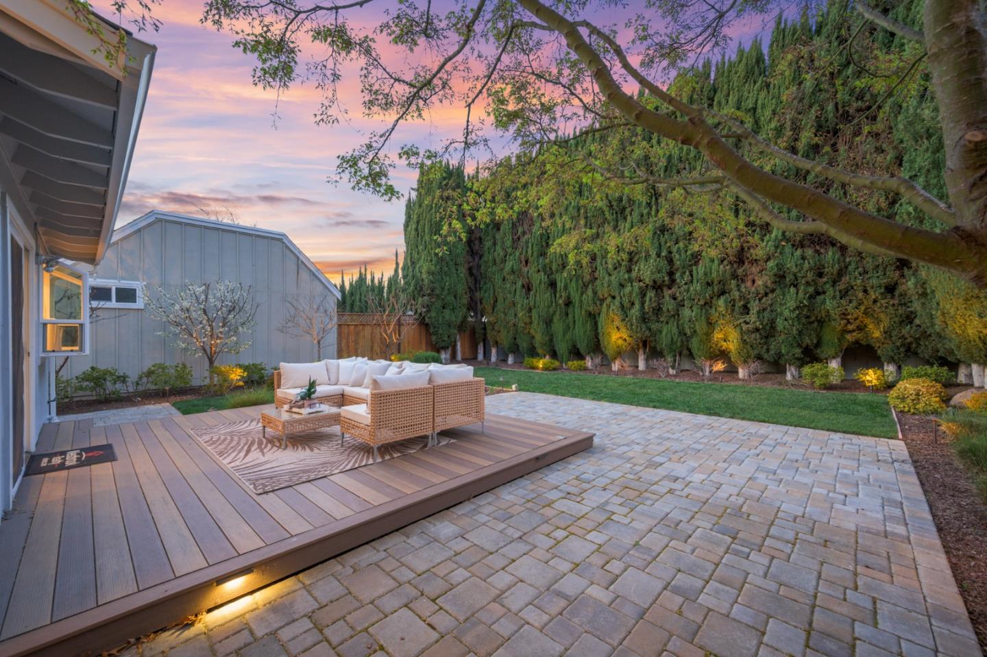 207 Post Street Mountain View, CA 94040 - Photo 46 of 60 a view of a patio with couches and table and chairs next to yard with wooden fence
