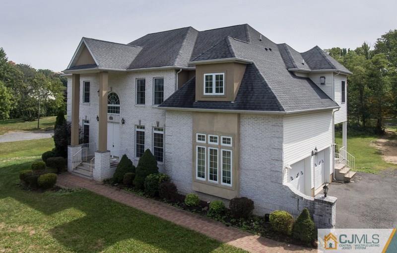 238 Fresh Ponds Road Monroe Township, NJ 08831 - Photo 1 of 17 a front view of a house with garden