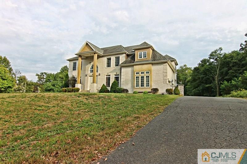 238 Fresh Ponds Road Monroe Township, NJ 08831 - Photo 2 of 17 a front view of a house with a yard
