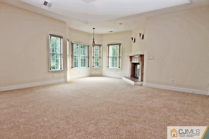 238 Fresh Ponds Road Monroe Township, NJ 08831 - Photo 11 of 17 a view of a big room with windows and chandelier fan