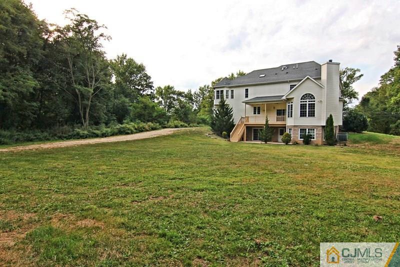 238 Fresh Ponds Road Monroe Township, NJ 08831 - Photo 3 of 17 a front view of a house with a yard