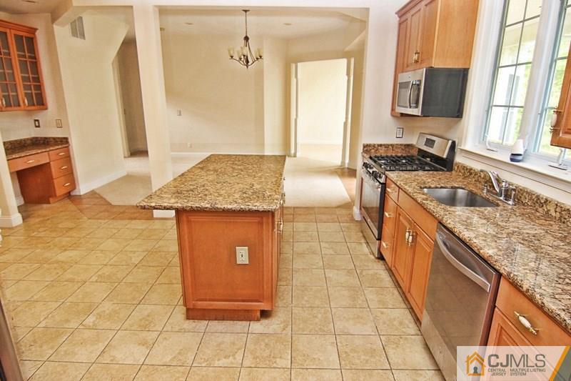 238 Fresh Ponds Road Monroe Township, NJ 08831 - Photo 10 of 17 a kitchen with stainless steel appliances granite countertop a sink stove and cabinets