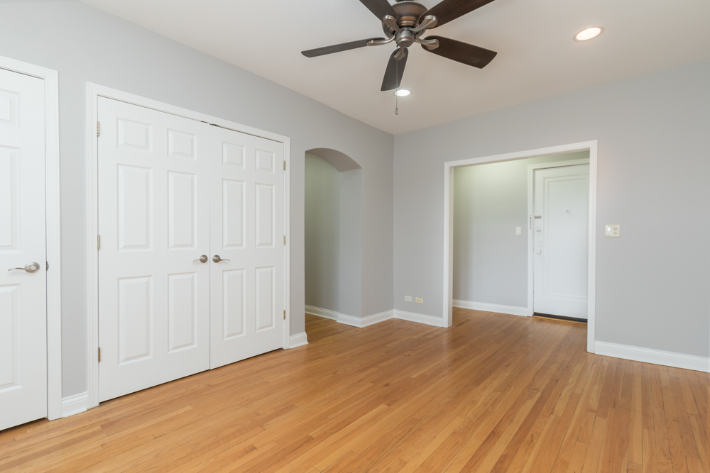 54 Forest Avenue, Unit 3W Riverside, IL 60546 - Photo 3 of 6 an empty room with wooden floor closet and fan chandelier fan