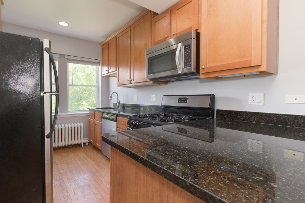 54 Forest Avenue, Unit 3W Riverside, IL 60546 - Photo 4 of 6 a kitchen with stainless steel appliances granite countertop a stove a sink and a microwave