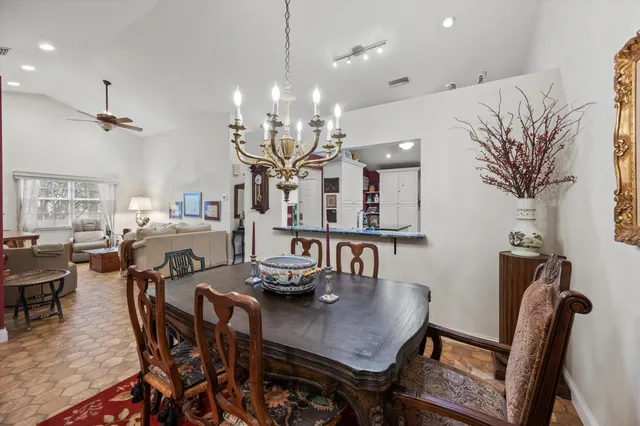 a view of a dining room with furniture and chandelier