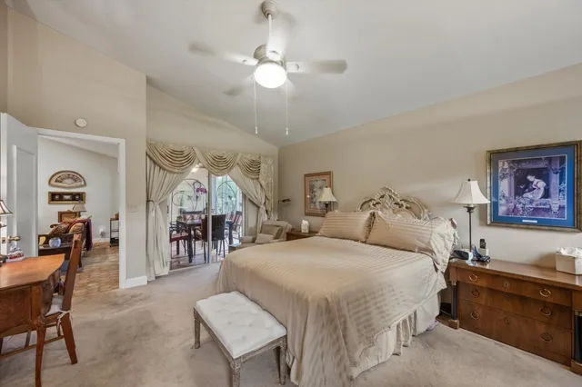 a spacious bedroom with a bed a couch and dresser