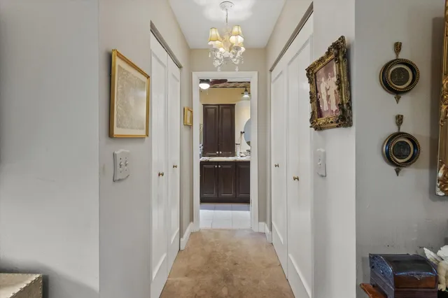 a view of a hallway to rooms and wooden floor