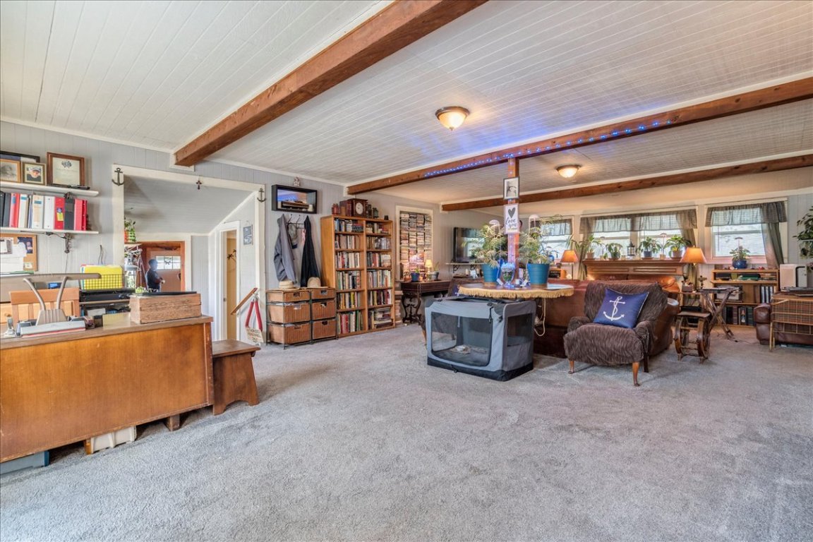 2411 Rohde Road Kyle, TX 78640 - Photo 11 of 40 Living room featuring beam ceiling and carpet floors