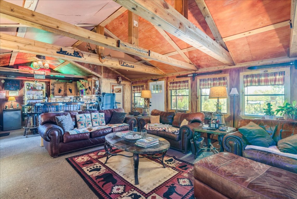 2411 Rohde Road Kyle, TX 78640 - Photo 17 of 40 Living area featuring carpet flooring and wooden walls