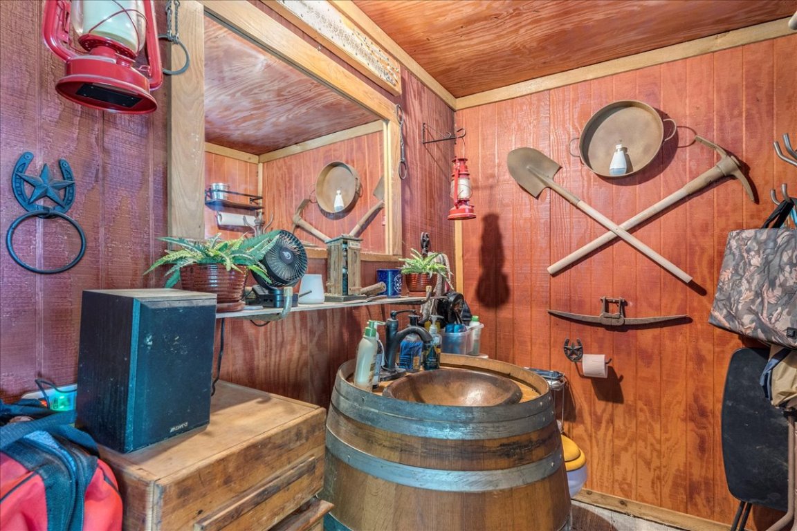 2411 Rohde Road Kyle, TX 78640 - Photo 25 of 40 Half bathroom with wood walls and vanity