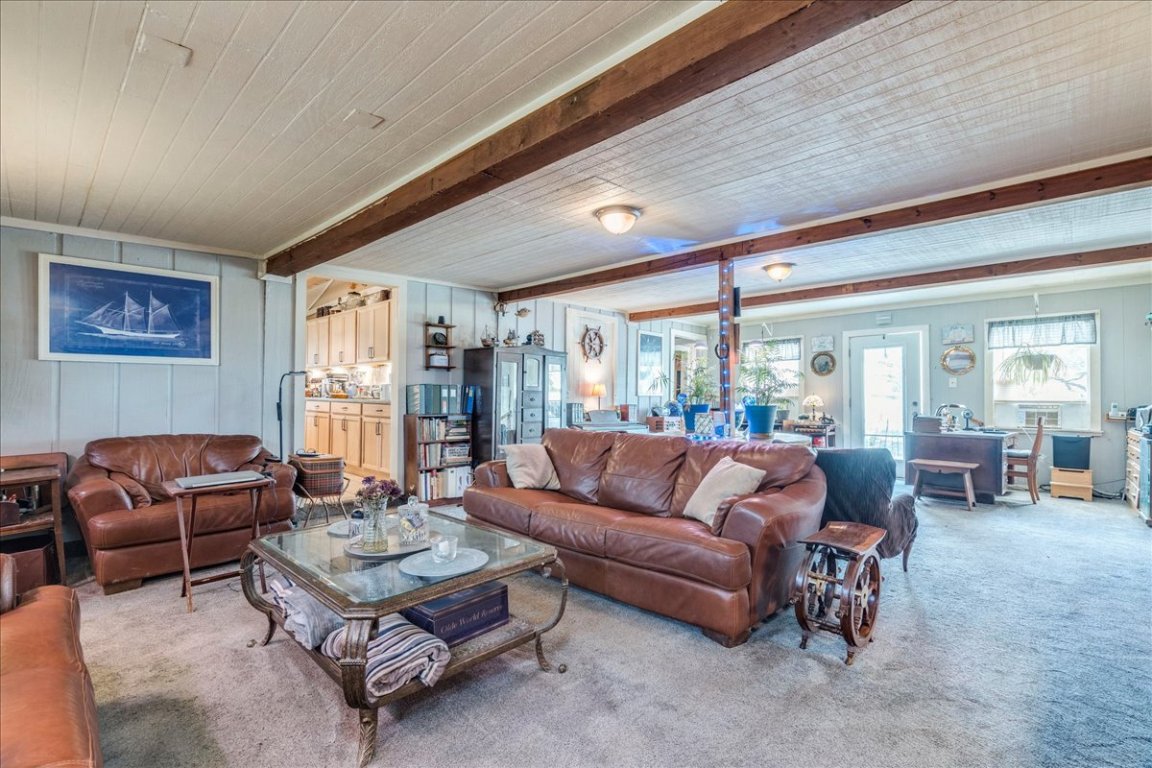 2411 Rohde Road Kyle, TX 78640 - Photo 10 of 40 Living room with carpet flooring and a wooden ceiling with exposed beams