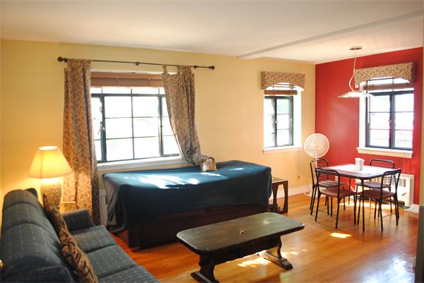79 Sutherland Road, Unit 1 Boston, MA 02135 - Photo 2 of 10 a living room with furniture and wooden floor