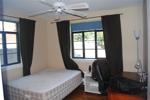 79 Sutherland Road, Unit 1 Boston, MA 02135 - Photo 9 of 10 a bedroom with a bed and wooden floor