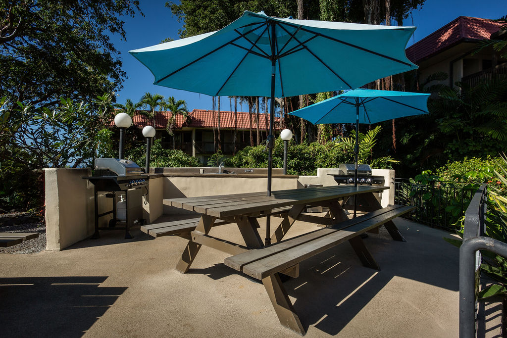 75-5873 Walua Road, Unit 212 Kailua-Kona, HI 96740 - Photo 15 of 17 a view of a backyard with sitting area and furniture