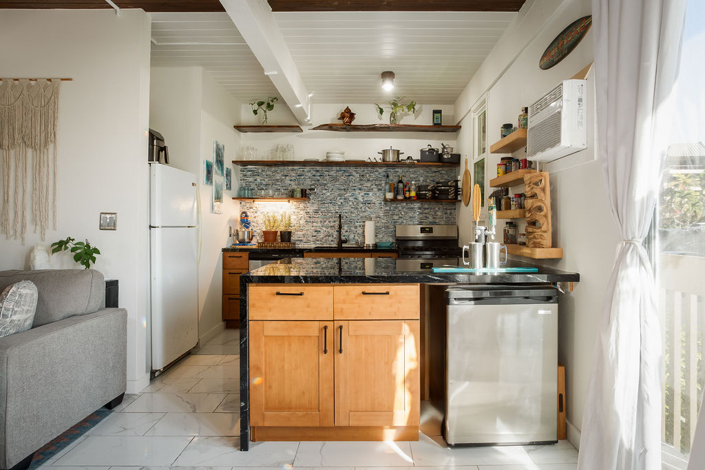 75-5873 Walua Road, Unit 212 Kailua-Kona, HI 96740 - Photo 3 of 17 a kitchen with stainless steel appliances granite countertop a stove and a refrigerator