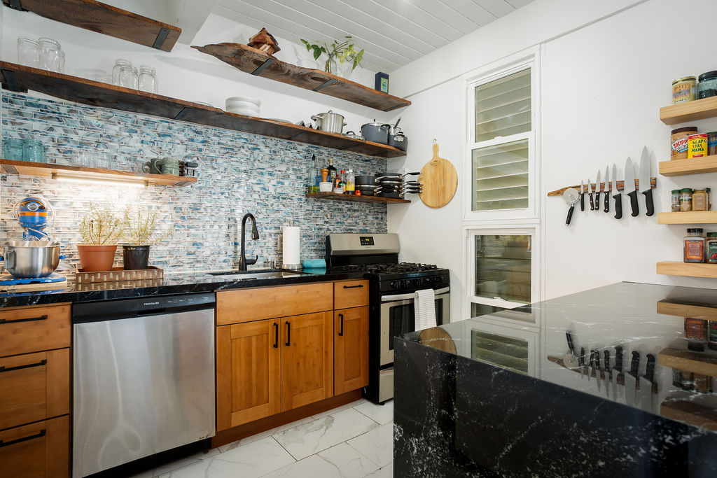 75-5873 Walua Road, Unit 212 Kailua-Kona, HI 96740 - Photo 5 of 17 a kitchen with stainless steel appliances granite countertop a sink and cabinets