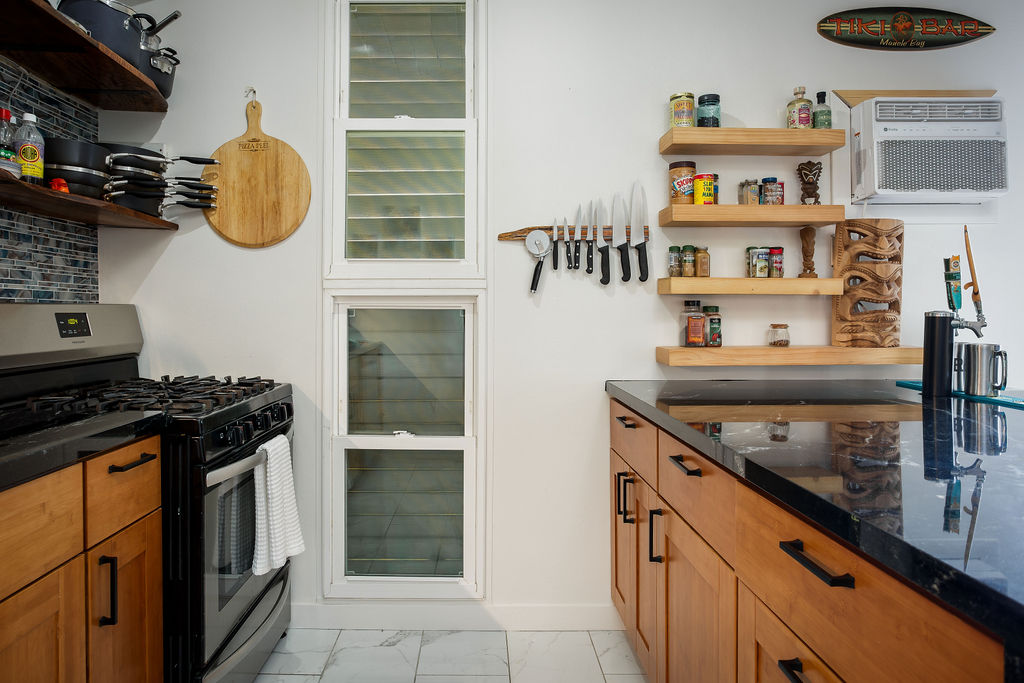75-5873 Walua Road, Unit 212 Kailua-Kona, HI 96740 - Photo 6 of 17 a kitchen with stainless steel appliances granite countertop a stove and a refrigerator