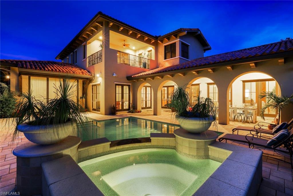 a view of a house with swimming pool and sitting area