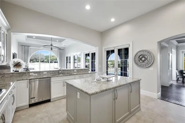 a kitchen with a sink and a clock