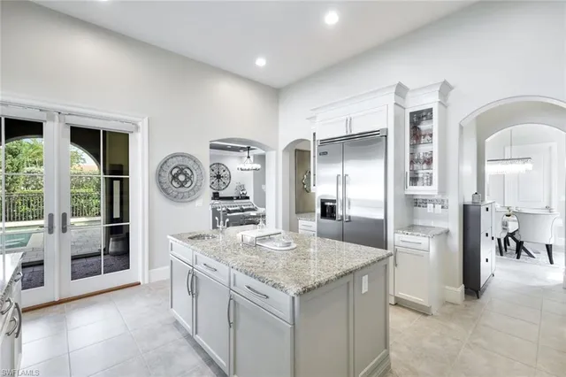 a kitchen with stainless steel appliances granite countertop a refrigerator and stove