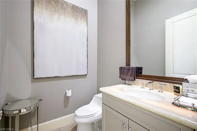 a bathroom with a sink a toilet and mirror