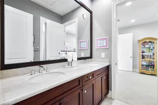 a bathroom with a sink double vanity and a mirror