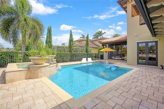 a view of swimming pool with outdoor seating and plants