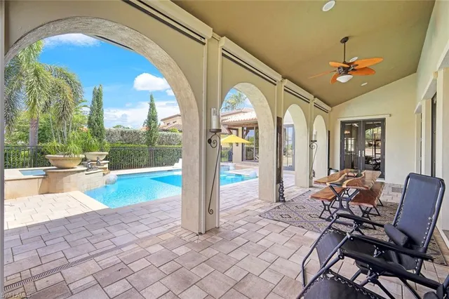 a view of a dining room with furniture fire place and chandelier