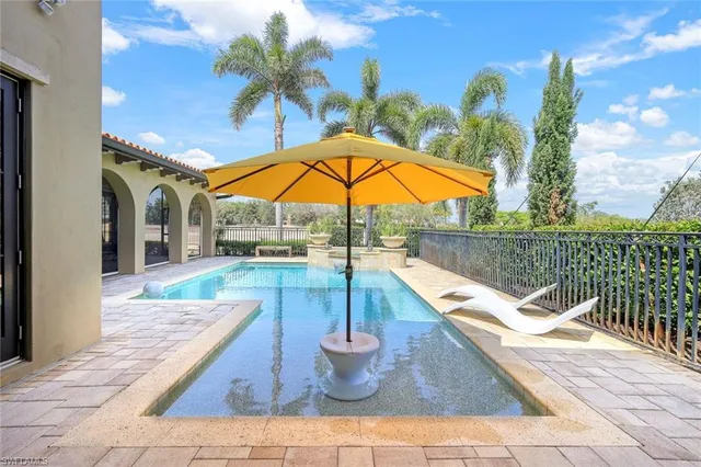 a view of a patio with a table and chairs