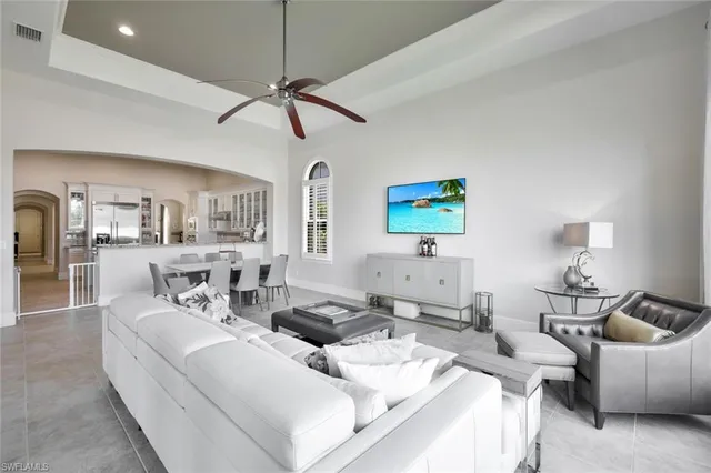 a living room with furniture and a lamp