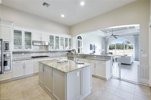 a kitchen with a sink stove and cabinets