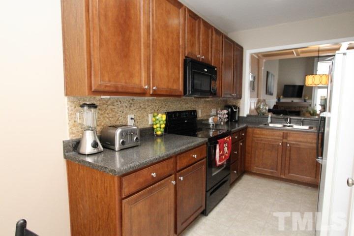 2520 Asher View Court Raleigh, NC 27606 - Photo 8 of 24 Kitchen with pantry, natural stone backsplash and ample 42 in cabinetry.