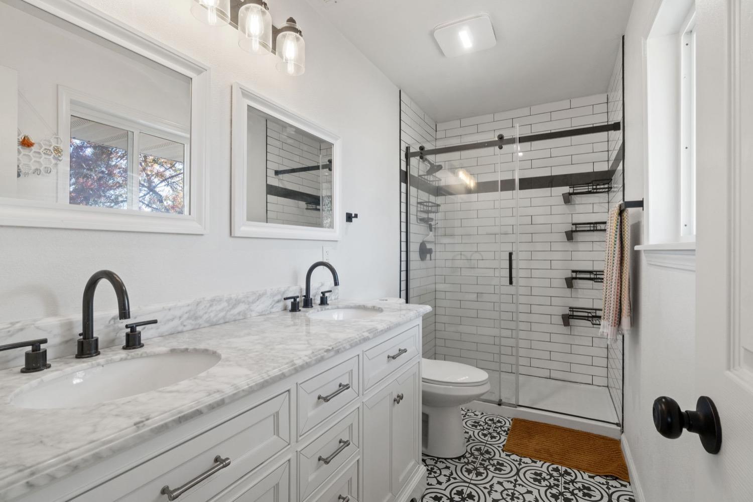 43299 Ranger Cir Drive Coarsegold, CA 93614 - Photo 22 of 44 a bathroom with a granite countertop sink a toilet and a mirror