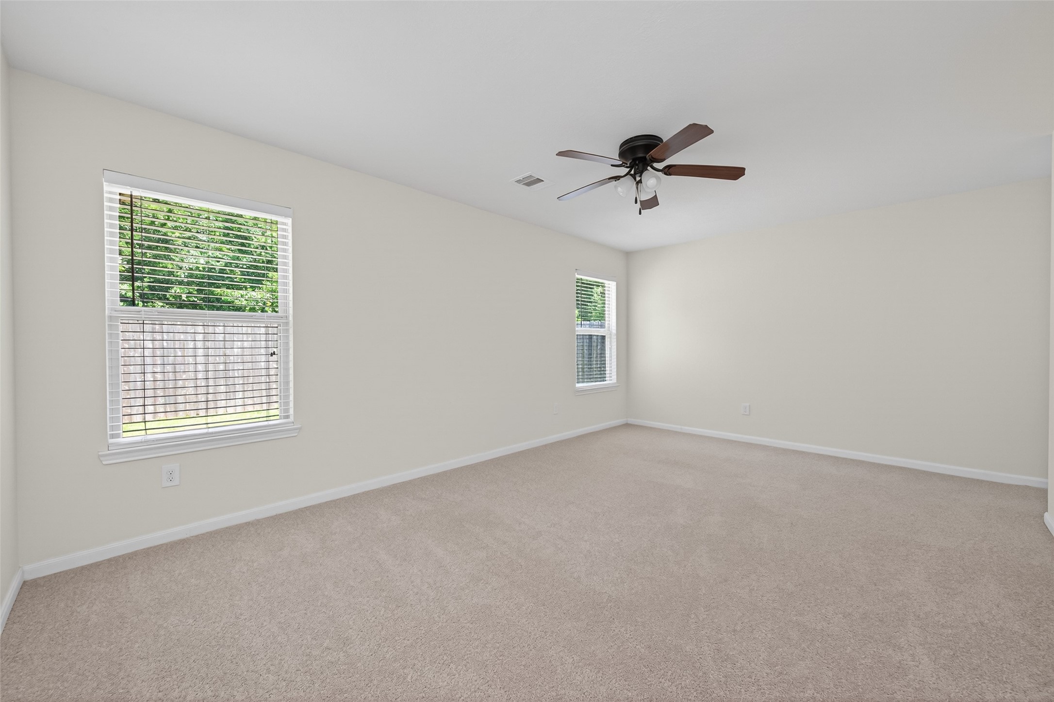 2754 Cayden Creek Way Conroe, TX 77304 - Photo 22 of 40 an empty room with windows and fan