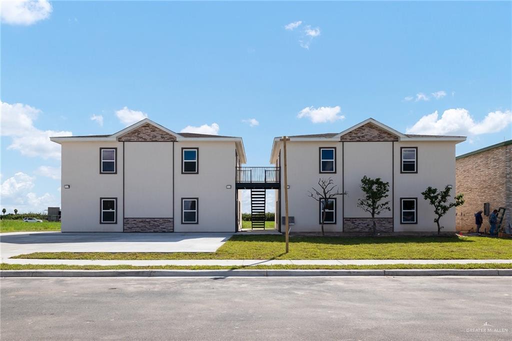 2602 Clearview Street Weslaco, TX 78596 - Photo 2 of 15 a view of a house with a swimming pool and a large tree