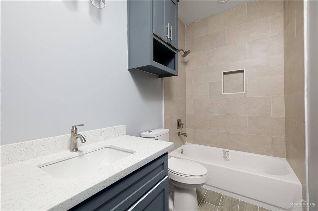 2602 Clearview Street Weslaco, TX 78596 - Photo 6 of 15 a bathroom with a sink a toilet and shower