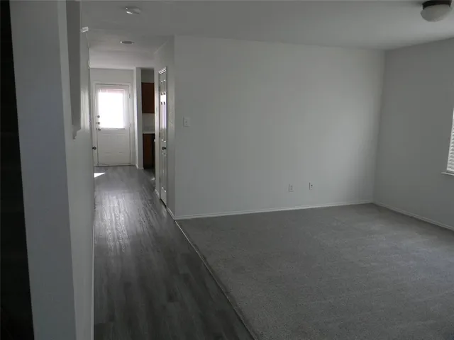 a view of a room with wooden floor and windows